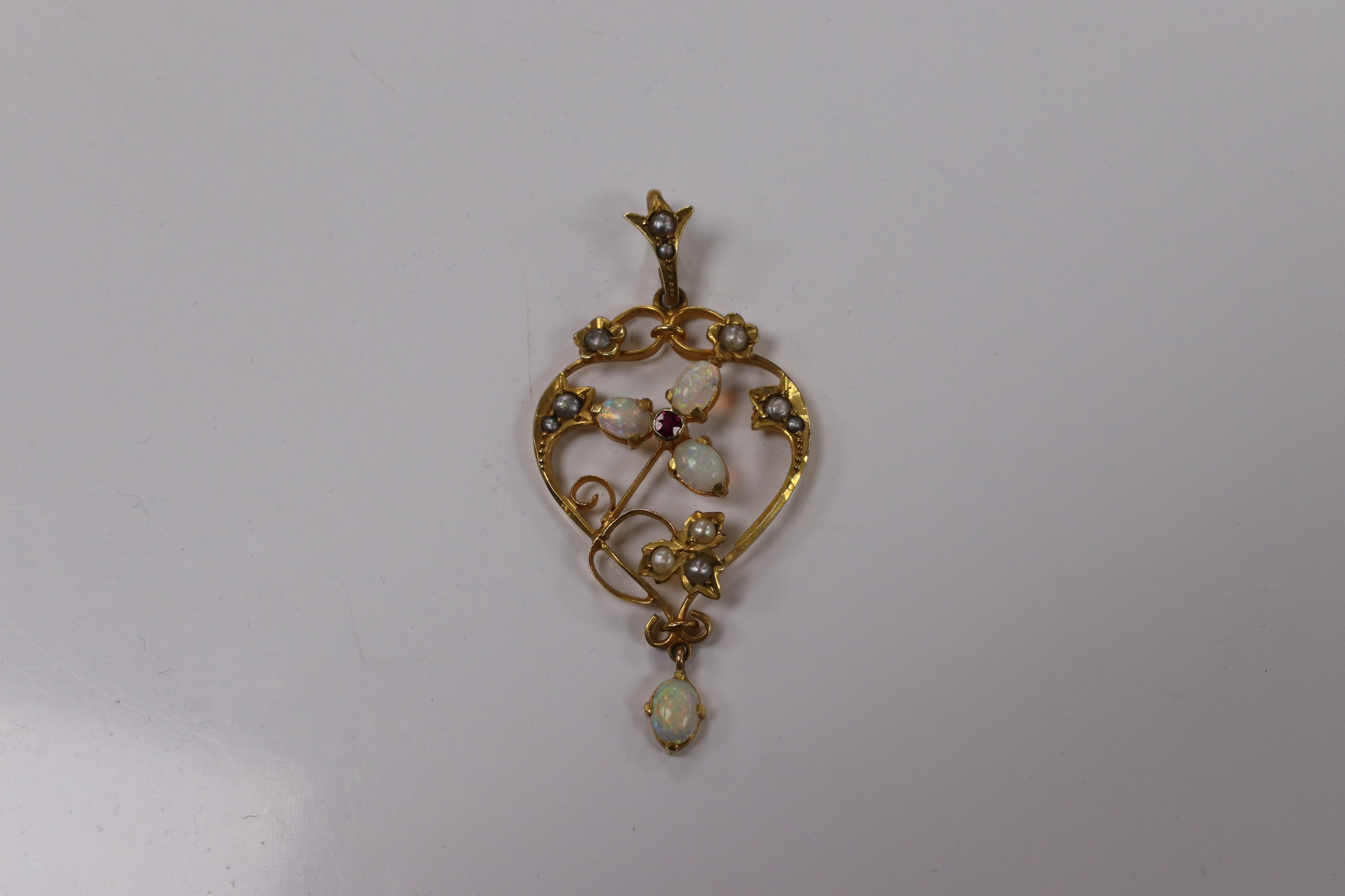 An Edwardian 9ct, white opal, seed pearl and ruby set drop pendant, 43mm, together with a yellow metal , seed pearl and rose cut diamond set brooch. Condition - fair
